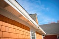 closeup of gambrel roof shingles on a sunny day