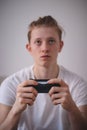 Closeup of a game controller and a player who is intently watching what to do in a video game. Busy and fully focused performance Royalty Free Stock Photo