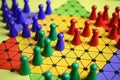 Closeup of gameboard with hexagram, colorful pieces of strategy game sternhalma or chinese checkers Royalty Free Stock Photo