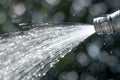 closeup of a garden hose nozzle spraying water Royalty Free Stock Photo