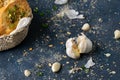 Closeup garlic cloves and herbed bread on a gray table