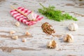 Closeup of garlic, peppercorns and rosemary leaves on wooden surface