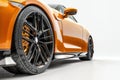 Closeup on a generic orange sport car isolated on a white background Royalty Free Stock Photo