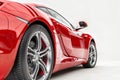 Closeup on a generic red sport car isolated on a white background Royalty Free Stock Photo