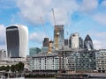 Closeup of the Gherkin between two skyscrapers under construction in the London City Royalty Free Stock Photo