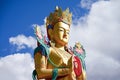 Closeup giant Maitreya Buddha statue with blue sky with clouds.