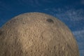 Closeup of a giant model of the Moon against a blue sky in Brno Observatory and Planetarium