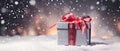 A Closeup of a Gift Box with a Red Ribbon on Top Against a Snowy