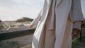 Closeup girl body strolling wooden pier. Calm serene woman touching railings