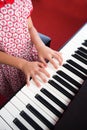 Closeup girl hand playing piano. Favorite music for learning to basic of music and rhythm skill. Royalty Free Stock Photo