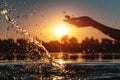 Closeup of girl hand silhouette play or splash water in lake on beach at sunset