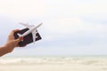 Closeup of girl holding Airplane and passports on summer nature landscape of white sand beach, travel concept Royalty Free Stock Photo