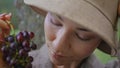 Closeup girl holding grape bunch on vineyard. Portrait lady looking on berries Royalty Free Stock Photo