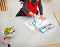 Closeup on girl painter drawing pumpkin Jack-O-Lantern on paper Royalty Free Stock Photo