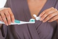 Closeup on girl squeezing toothpaste on toothbrush Royalty Free Stock Photo