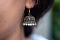 Closeup girl wearing Indian style earrings or Jhumka