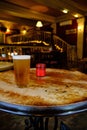 Closeup of a glass of beer on the table under the lights in the bar with a blurred background Royalty Free Stock Photo