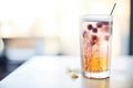 closeup of a glass of blackcurrant soda with fizzing bubbles