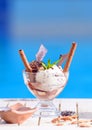 Closeup of glass bowl with mint, vanilla ice cream scoops on blur bokeh background with copy space. Waffle chocolate rolls Royalty Free Stock Photo