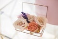 Closeup glass box for wedding rings decorated with fresh rose flowers and banch of lavender. Event decoration with fresh flowers Royalty Free Stock Photo