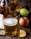 Closeup of a Glass of Cider with Ripe Apples Wooden Background Vertical