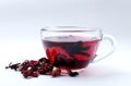 Closeup of glass cup of natural hibiscus tea and dried petals on th wt backgrund Royalty Free Stock Photo