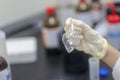 Closeup of a glass flask broken in a hand of scientist in the lab Royalty Free Stock Photo