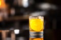 Closeup glass of godfather cocktail with slice of orange Royalty Free Stock Photo