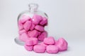 Glass jar full of pink heart-shaped candies on a white background Royalty Free Stock Photo