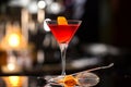 Closeup glass of Manhattan cocktail decorated with orange