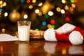 Closeup of glass of milk and cookies for Santa on table Royalty Free Stock Photo