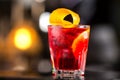 Closeup glass od red alcoholic cocktail decorated with lemon Royalty Free Stock Photo