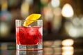 Closeup glass of red negroni cocktail at bar counter