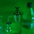 Closeup of a glass smoking banger on blur green background