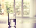 Closeup Glass of water on table in the living room , vintage and retro style Royalty Free Stock Photo