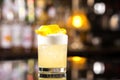 Closeup glass of whiskey sour cocktail decorated with lemon at b Royalty Free Stock Photo