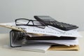 Pile of documents, paperwaork, glasses and calculator, notebook on the office desk Royalty Free Stock Photo