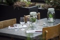 glasses and decoration on the table at the restaurant terrasse in the street Royalty Free Stock Photo