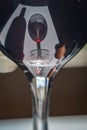 Closeup of glasses of red wine and bottle with shadows and reflections Royalty Free Stock Photo