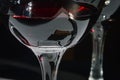 Closeup of glasses of red wine and bottle with shadows and reflections Royalty Free Stock Photo