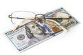 Closeup glasses on US 100 hundred dollar bill or banknote background