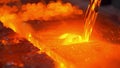 A closeup of glowing redhot molten silicon being poured into a mold as part of the production process for solar panel