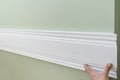 Closeup of gluing wooden white painted plank panel on wall, closeup, carpentry, woodwork, profession, people