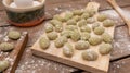 Closeup of Gnocchis on a wooden dock against blurred background