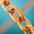 Closeup of a gold chain link against a blue background Royalty Free Stock Photo