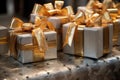 closeup of gold and silver-wrapped boxes with ribbons and bows