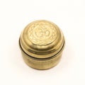 closeup of a golden bronze box jar with hindu om symbol