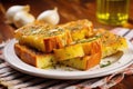 closeup of golden-brown grilled garlic bread on a plate