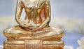 Closeup golden Buddha statue with Jasmine flower on hands Royalty Free Stock Photo