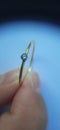Closeup of golden 14k ring with a small blue crystal Royalty Free Stock Photo